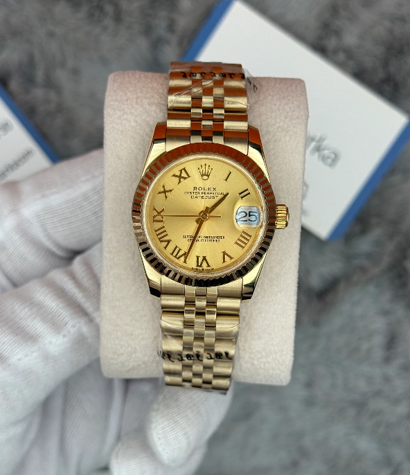 Rolex Datejust with a gold dial, Roman numerals, and a Jubilee bracelet