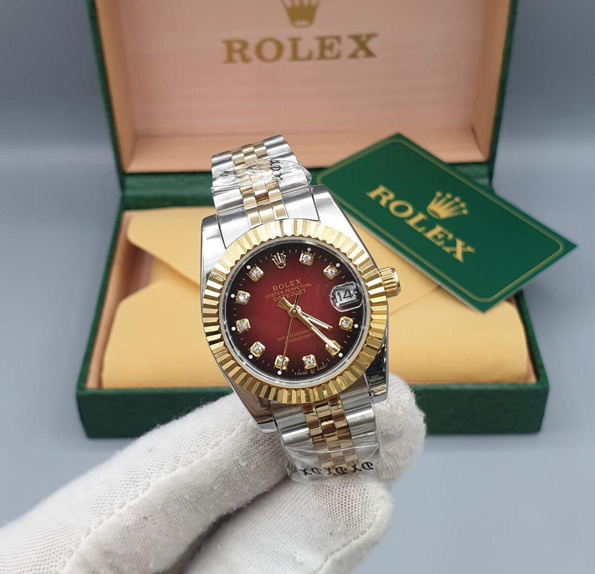 Rolex Datejust yellow gold design with a red dial and diamond hour marker